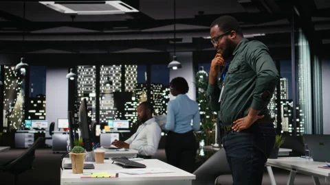 Black general manager thinking about a complex problem in a dark office late Stock Footage 318499370