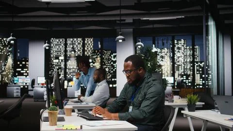 Black general manager thinking about a complex problem in a dark office late Stock Photos