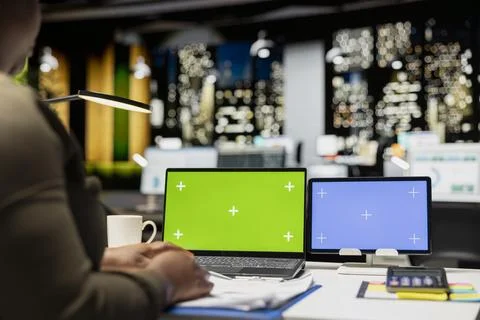 Black general manager working with chroma key on laptop and tablet Stock Photos