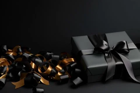Black gift box on black background with empty space for text. Stock Photos