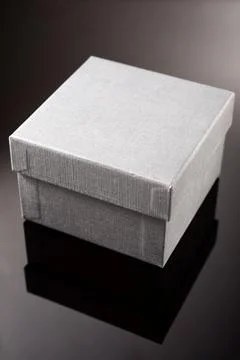 Black gift box on a black table Stock Photos