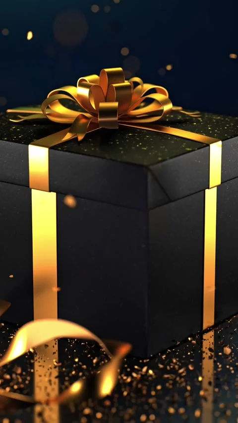 Black gift box with a golden bow on a glitter-dusted dark background. The s.. Stock Footage 295346354