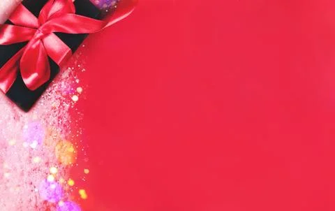 Black gift box on red background. Stock Photos