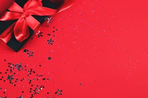 Black gift box on red background. Stock Photos