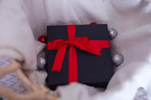 Black gift box with a red bow Stock Photos