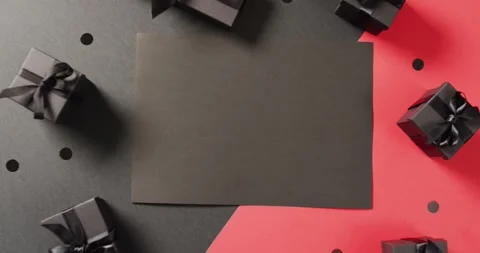 Black gift boxes with black ribbons on black and red background with copy space Stock Footage 339412721
