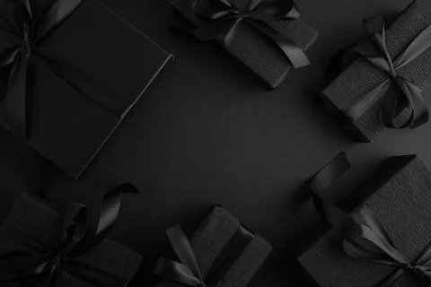 Black gift boxes with elegant shiny satin ribbons Stock Photos