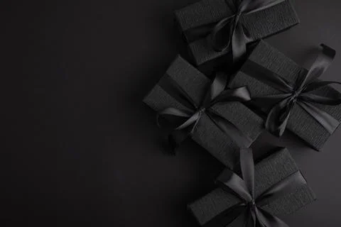 Black gift boxes with elegant silk ribbons Stock Photos