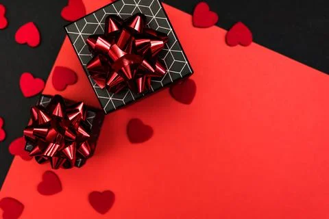 Black gift boxes with geometric pattern, decorated with red bows Stock Photos
