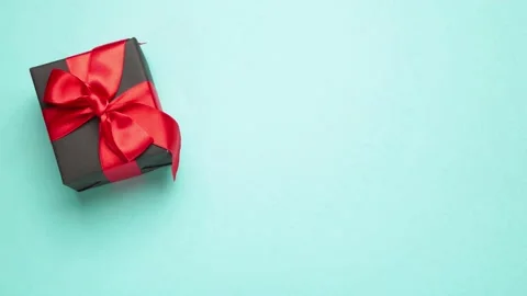 Black gift moves on blue background. Shopping sale discount. Stock Footage 139610083