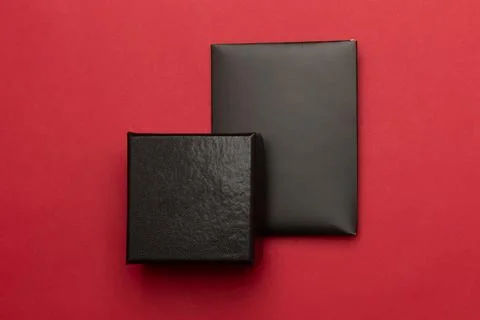 Black giftbox with envelope card on red background, Black friday campaign Stock Photos