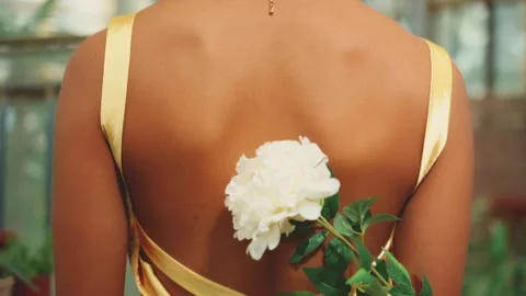 Black girl bare open back, man hand stroking with fresh white peony flower Stock Footage 307037026
