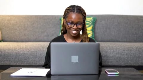 A black girl joining a webinar using a laptop Stock Footage 265236951