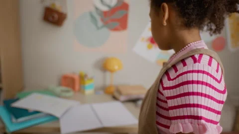 Black Girl Packing Notebook in Backpack, Preparing for School Stock Footage 337563342
