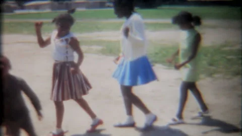 Black girls practice dance moves on playground 1950s family home movie 7067 Stock Footage 201159732