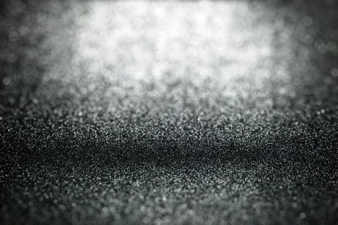 Black glitter background with selective focus and blurred foreground Stock-Fotos
