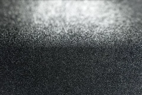 Black glitter texture background with defocused in background Stock Photos