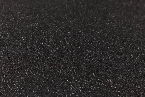 Black glitter texture background. Defocused festive backdrop. Stock Photos