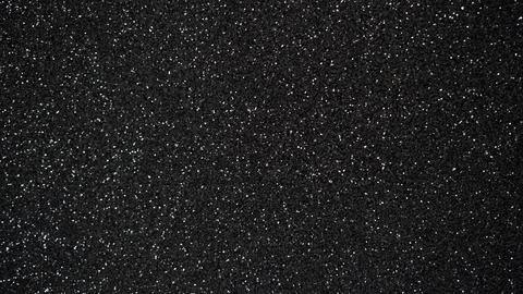 Black glitter texture background with sparkling particles for design Stockfoto's