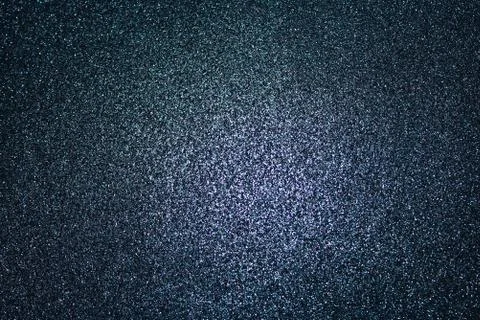 Black glittery background with light in the centre Stock Photos