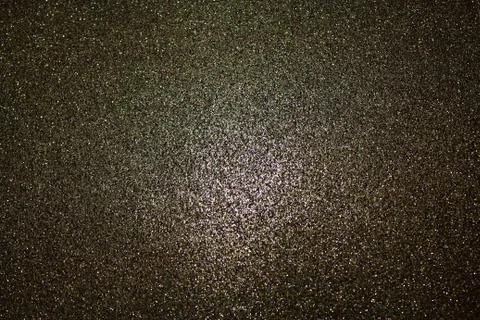 Black glittery background with light in the centre Stock Photos