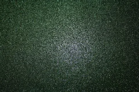 Black glittery background with light in the centre Stock Photos