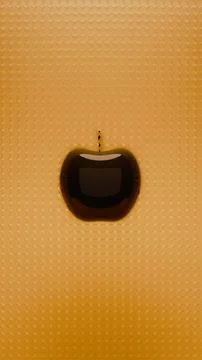 Black glossy apple shape floating centrally above dense orange circle grid .. Stock Illustration