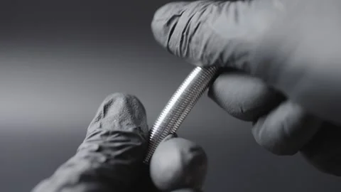 A black glove on the hands , a spring is shown in the hands and how it bends in  Stock Footage 304536443