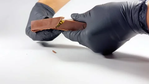 Black-gloved hands cracking Dubai chocolate Stock Footage 293645088
