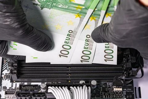 Black-gloved hands inserting 100 euro banknotes into empty RAM slots on a m.. Stock Photos