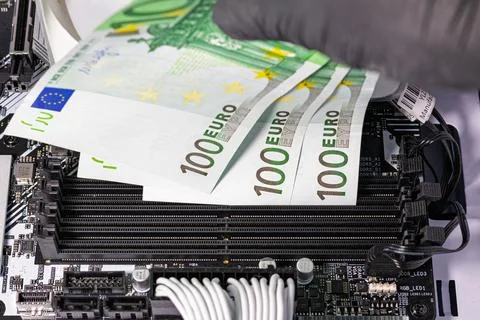 Black-gloved hands inserting 100 euro banknotes into empty RAM slots on a m.. Stock Photos