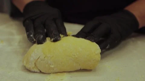 Black gloved hands making pasta dough, pizza dough. Stock Footage 300028375