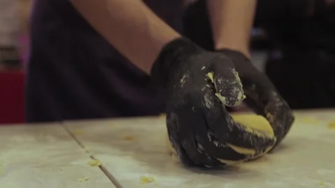 Black gloved hands making pasta dough, pizza dough. Stock Footage 300028377