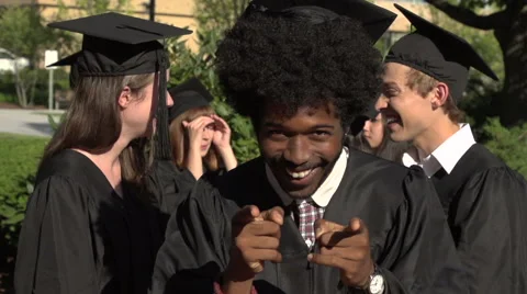 A black graduation student points excitedly at camera - slow motion Stock Footage 44111985