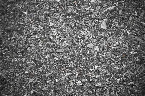 Black Grainy road surface texture. Top view grunge rough asphalt background Stock Photos