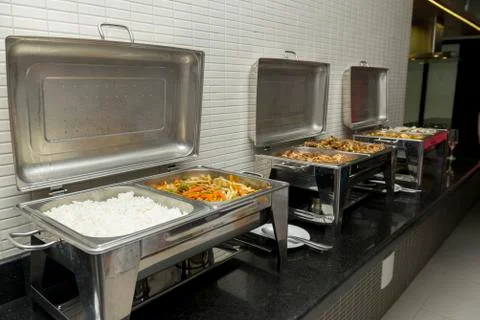 Black granite counter tops with food that will be served at the wedding Stock Photos