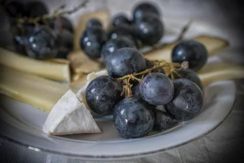 Black grape and cheese Stock Photos