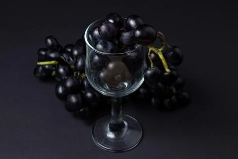 Black grapes on a black background. Stock Photos