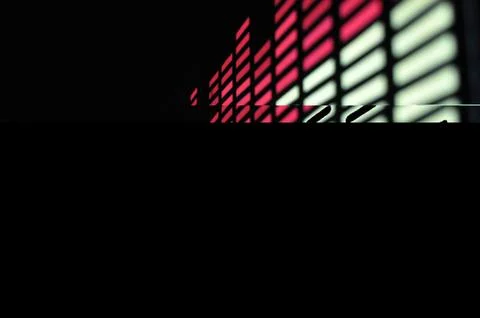 Black graphic background with rectangular luminous pixels of red and yellow Stock Photos