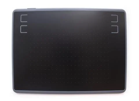 Black graphic design tablet with control buttons on a white background. Stock Photos