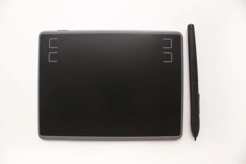 Black graphic design tablet with control buttons on a white background. Graph Stock Photos