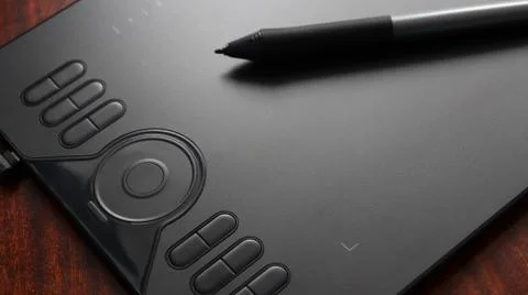 Black graphic tablet with pen on table Stock Photos
