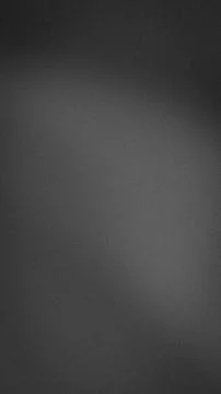 Black gray and dim gray grainy abstract background vertical format tech wal.. 库存照片