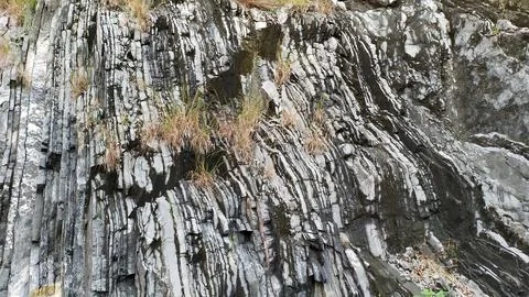 Black, gray, graphite striped texture, flat stone with cracks Stock Photos