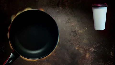 Black grill pan on fire with coffee cup Stock Footage 131858346