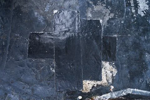 Black grunge wall texture with black cloth tape Stockfoto's