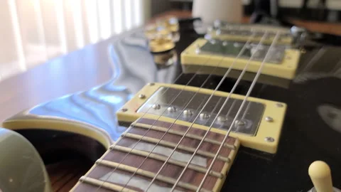 Black guitar close up and coffee on the side Stock Footage 149727941