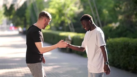 Black guy and white guy greet each other in a special greeting Stock Footage 132365186