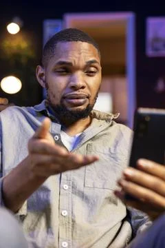 Black guy attending a virtual workshop lecture via online conference Stock Photos
