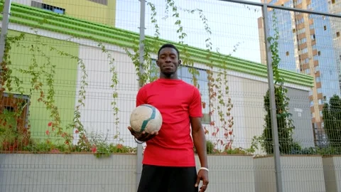 A black guy with a ball in his hands approaches the camera Stock Footage 139643354